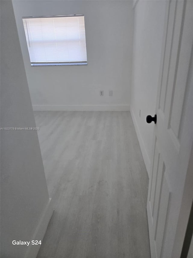 1000 W 28th St Unit 17, Hialeah, FL 33010 - spare room with baseboards and light wood-style flooring