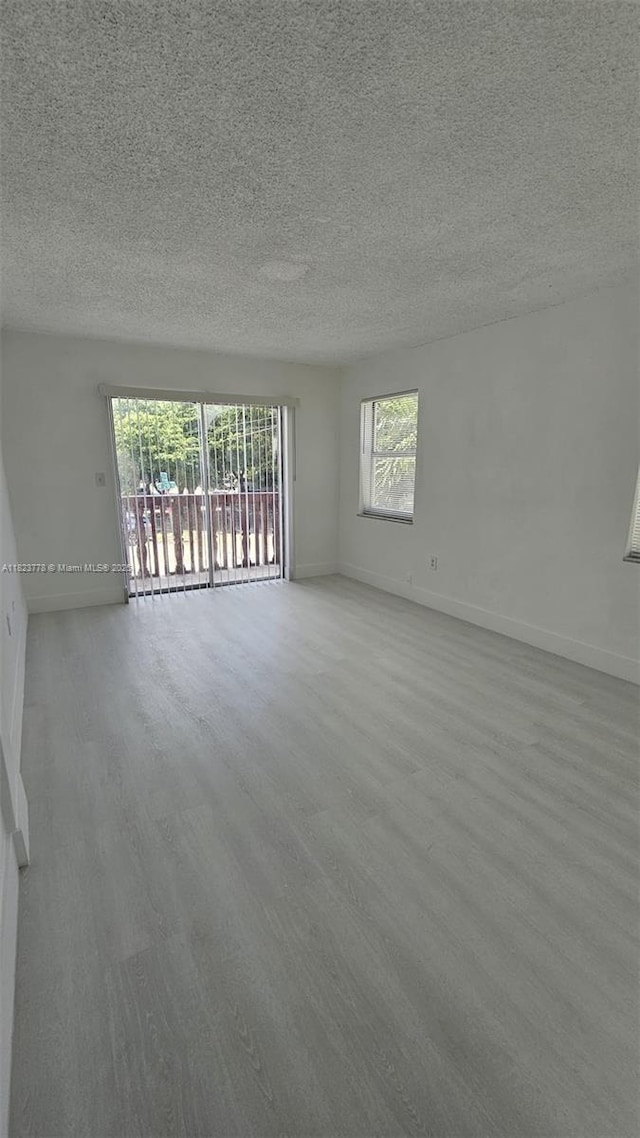 1000 W 28th St Unit 17, Hialeah, FL 33010 - unfurnished room with a textured ceiling and wood finished floors