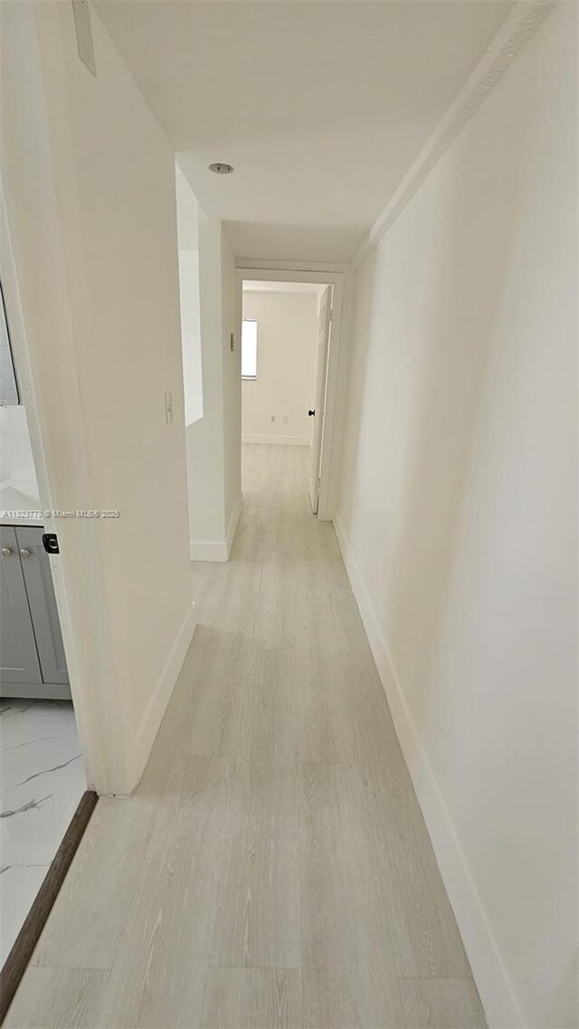 1000 W 28th St Unit 17, Hialeah, FL 33010 - hallway featuring baseboards and light wood-style floors