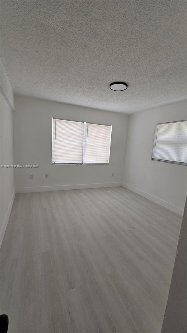 1000 W 28th St Unit 17, Hialeah, FL 33010 - spare room featuring wood finished floors and a textured ceiling