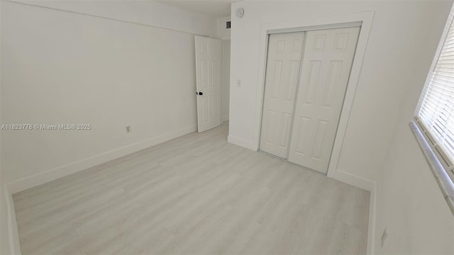 1000 W 28th St Unit 17, Hialeah, FL 33010 - unfurnished bedroom featuring wood finished floors and a closet