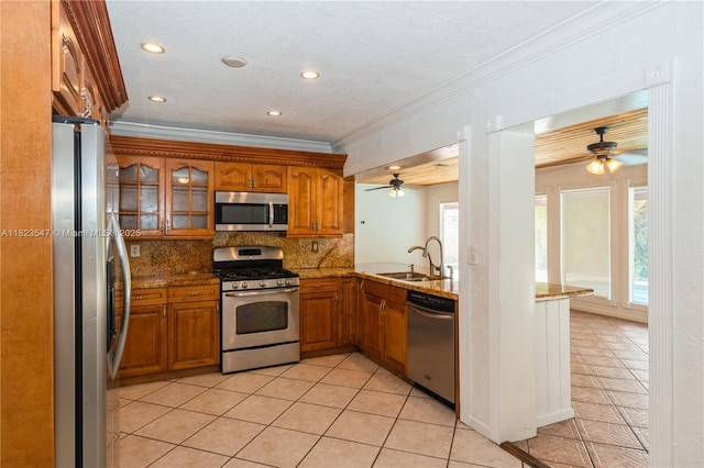 12540 SW 31st St, Miami, FL 33175 - kitchen featuring appliances with stainless steel finishes, ceiling fan, brown cabinets, crown molding, and recessed lighting