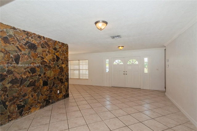 12540 SW 31st St, Miami, FL 33175 - entryway featuring ornamental molding, plenty of natural light, light tile patterned flooring, and a textured ceiling
