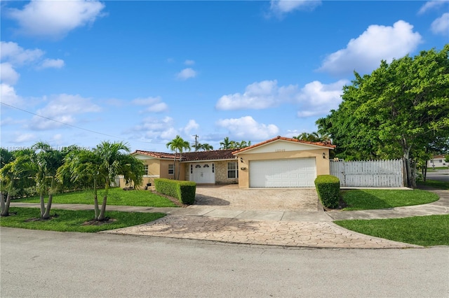 12540 SW 31st St, Miami, FL 33175 - view of front of property featuring stucco siding, decorative driveway, an attached garage, and a tile roof