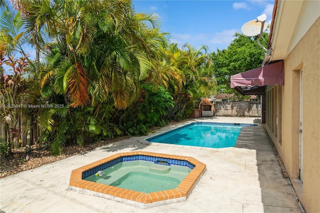 12540 SW 31st St, Miami, FL 33175 - view of swimming pool with an in-ground hot tub, a patio, a storage shed, and a fenced backyard