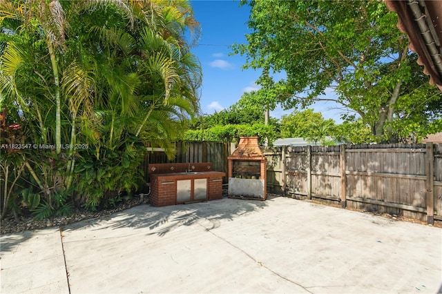 12540 SW 31st St, Miami, FL 33175 - fenced backyard with a patio and area for grilling