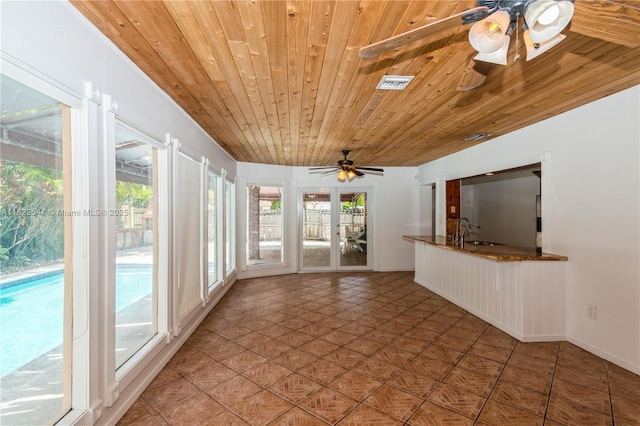 12540 SW 31st St, Miami, FL 33175 - unfurnished sunroom featuring wood ceiling, plenty of natural light, and tile patterned flooring