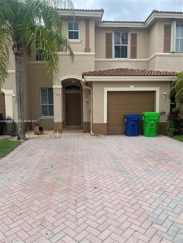 185 Riverwalk Cir, Sunrise, FL 33326 - multi unit property featuring decorative driveway, stucco siding, an attached garage, and a tile roof