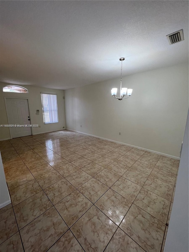 185 Riverwalk Cir, Sunrise, FL 33326 - tiled empty room with baseboards and a chandelier