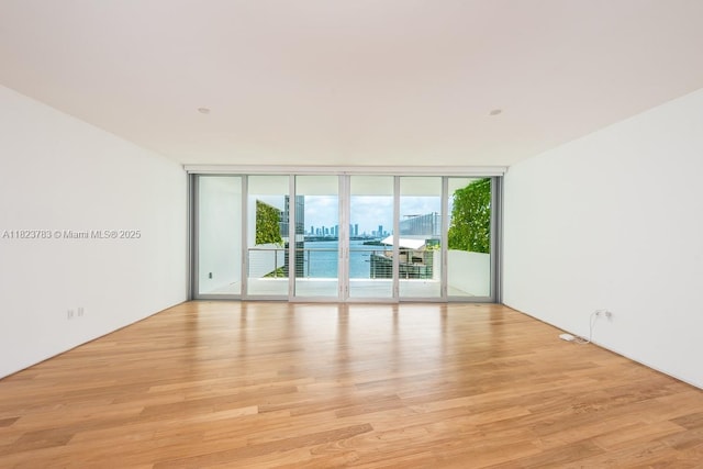 1300 Monad Ter Unit 9D, Miami Beach, FL 33139 - unfurnished room featuring a wall of windows and light wood-type flooring