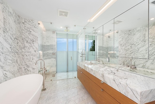 1300 Monad Ter Unit 9D, Miami Beach, FL 33139 - bathroom with tile walls, vanity, a marble finish shower, and a freestanding bath