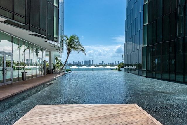 1300 Monad Ter Unit 9D, Miami Beach, FL 33139 - view of swimming pool featuring a skyline view and a dock