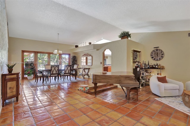 1180 NW 100th Way, Plantation, FL 33322 - tiled living area featuring vaulted ceiling and a textured ceiling