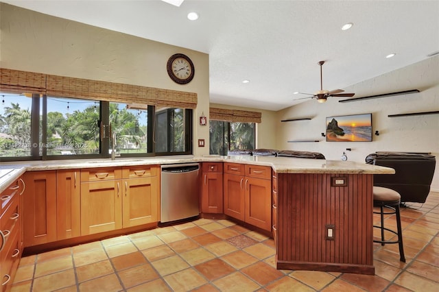 1180 NW 100th Way, Plantation, FL 33322 - kitchen with stainless steel dishwasher, a breakfast bar, open floor plan, ceiling fan, and a peninsula