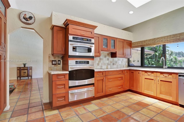 1180 NW 100th Way, Plantation, FL 33322 - kitchen with a warming drawer, stainless steel appliances, tasteful backsplash, recessed lighting, and brown cabinetry