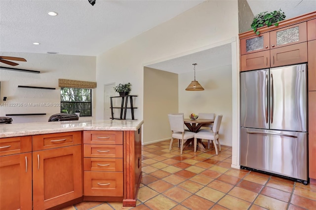 1180 NW 100th Way, Plantation, FL 33322 - kitchen with stainless steel refrigerator, glass insert cabinets, light stone countertops, a textured ceiling, and a ceiling fan