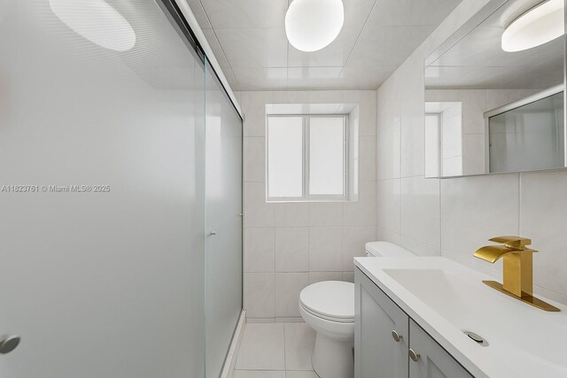 359 E 19th St, Hialeah, FL 33010 - full bath with vanity, a stall shower, tile patterned floors, and tile walls