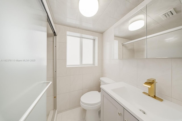 359 E 19th St, Hialeah, FL 33010 - full bathroom featuring tile walls, vanity, a shower with shower door, and tile patterned flooring