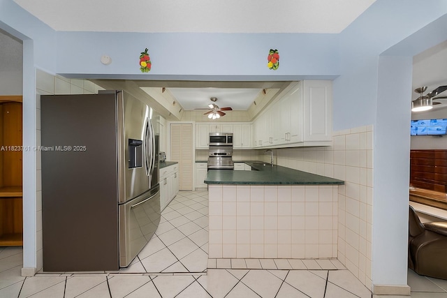 359 E 19th St, Hialeah, FL 33010 - kitchen with appliances with stainless steel finishes, dark countertops, a peninsula, white cabinetry, and a ceiling fan
