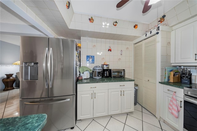 359 E 19th St, Hialeah, FL 33010 - kitchen with stainless steel appliances, backsplash, dark countertops, and tile walls