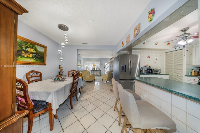 359 E 19th St, Hialeah, FL 33010 - dining room with light tile patterned floors, ceiling fan, and a textured ceiling