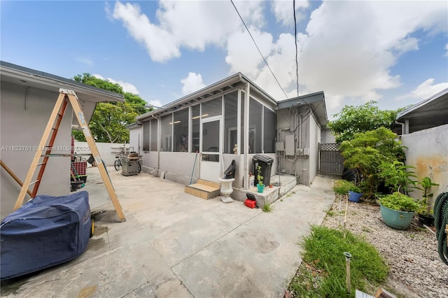 359 E 19th St, Hialeah, FL 33010 - back of house with a sunroom, a fenced backyard, and a patio