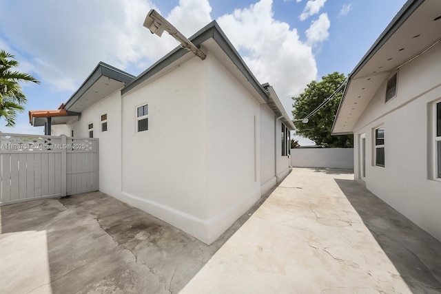 359 E 19th St, Hialeah, FL 33010 - view of home's exterior featuring stucco siding and a patio area