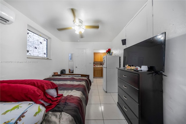 359 E 19th St, Hialeah, FL 33010 - bedroom featuring freestanding refrigerator, an AC wall unit, light tile patterned floors, ensuite bathroom, and a ceiling fan