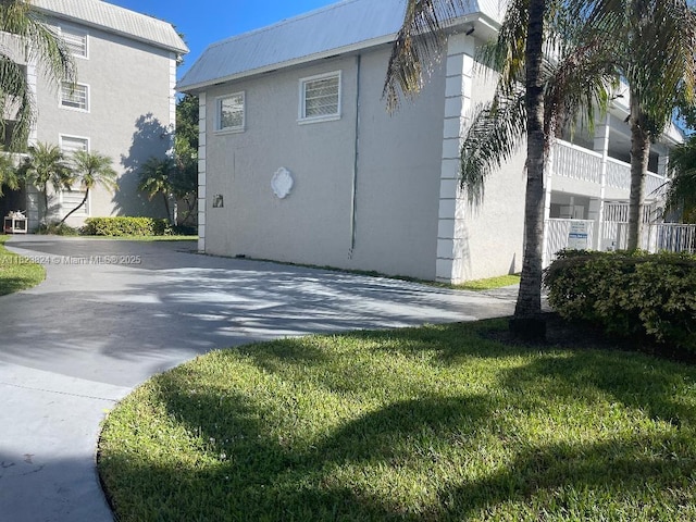 17255 SW 95th Ave Unit 153, Palmetto Bay, FL 33157 - view of home's exterior featuring stucco siding and a yard