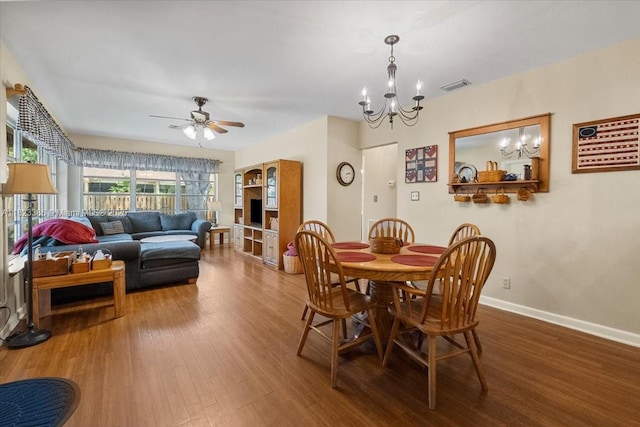 404 NE 11th Ave, Pompano Beach, FL 33060 - dining area with wood finished floors, a chandelier, and a ceiling fan