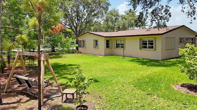 404 NE 11th Ave, Pompano Beach, FL 33060 - back of property featuring a lawn and stucco siding