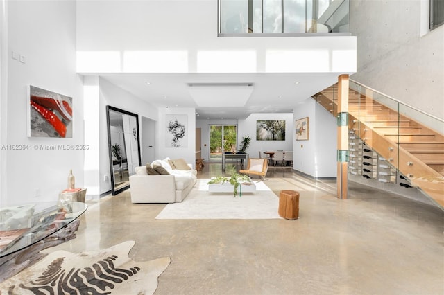 10620 SW 74th Ave, Pinecrest, FL 33156 - living room featuring a towering ceiling, concrete floors, and stairway
