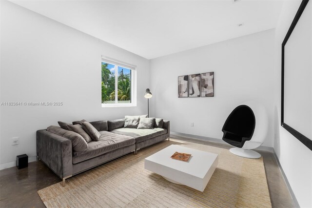 10620 SW 74th Ave, Pinecrest, FL 33156 - living room featuring concrete floors and baseboards