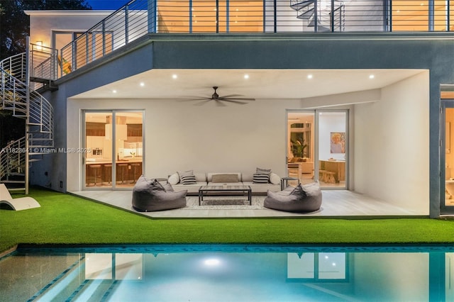 10620 SW 74th Ave, Pinecrest, FL 33156 - back of property with stucco siding, a balcony, ceiling fan, and an outdoor living space