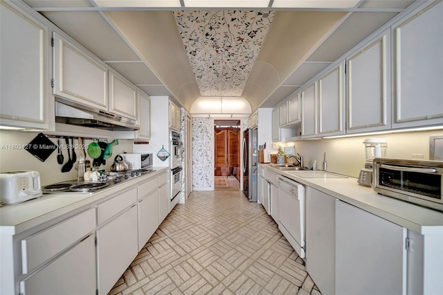 1800 NE 114th St Unit 604, Miami, FL 33181 - kitchen with ventilation hood, stainless steel appliances, brick patterned flooring, light countertops, and white cabinetry