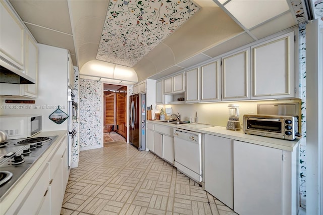 1800 NE 114th St Unit 604, Miami, FL 33181 - kitchen featuring appliances with stainless steel finishes, light countertops, white cabinets, and brick patterned floors