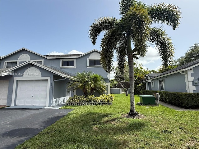 14251 SW 96th Ter Unit 14251, Miami, FL 33186 - view of front of house featuring stucco siding, a front lawn, an attached garage, and driveway