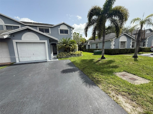 14251 SW 96th Ter Unit 14251, Miami, FL 33186 - view of front of property with stucco siding, a front yard, and driveway