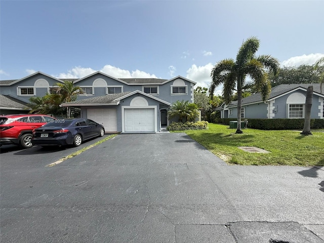 14251 SW 96th Ter Unit 14251, Miami, FL 33186 - view of front of house with asphalt driveway, a front lawn, and stucco siding