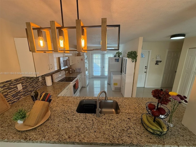 14251 SW 96th Ter Unit 14251, Miami, FL 33186 - kitchen with white appliances, light stone countertops, backsplash, tile patterned flooring, and a textured ceiling