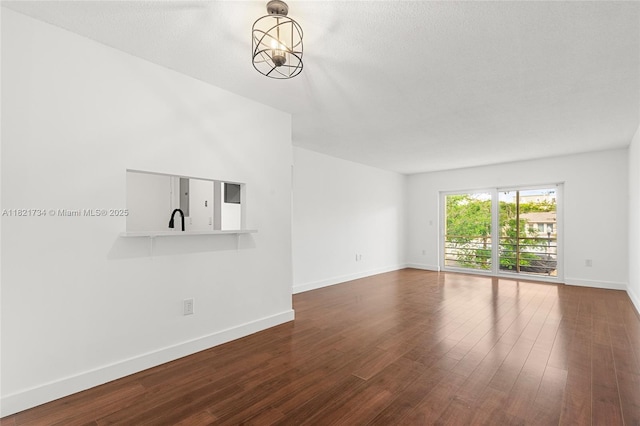 1912 Monroe St Unit 201, Hollywood, FL 33020 - unfurnished living room with dark wood-style flooring and baseboards