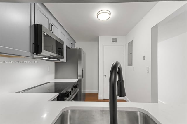 1912 Monroe St Unit 201, Hollywood, FL 33020 - kitchen with stainless steel microwave, light countertops, black electric range, and electric panel