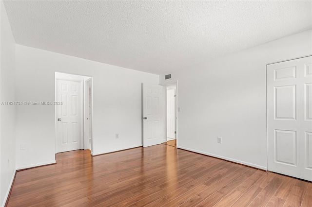 1912 Monroe St Unit 201, Hollywood, FL 33020 - spare room with wood finished floors and a textured ceiling