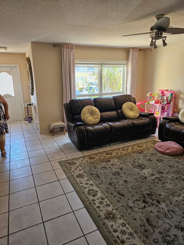 2423 NE 10th St Unit 154, Hallandale Beach, FL 33009 - living area featuring light tile patterned floors, a textured ceiling, and a ceiling fan