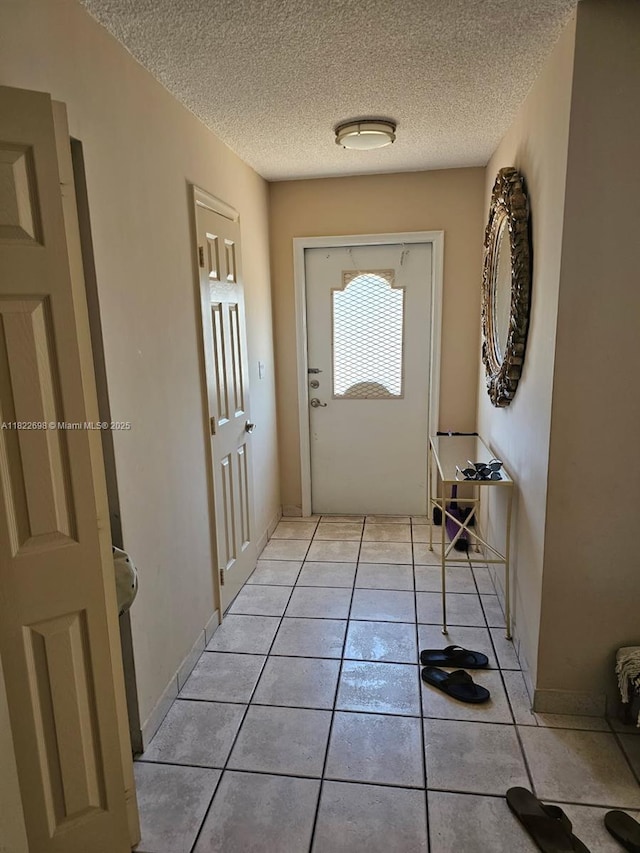 2423 NE 10th St Unit 154, Hallandale Beach, FL 33009 - entryway featuring a textured ceiling and light tile patterned floors