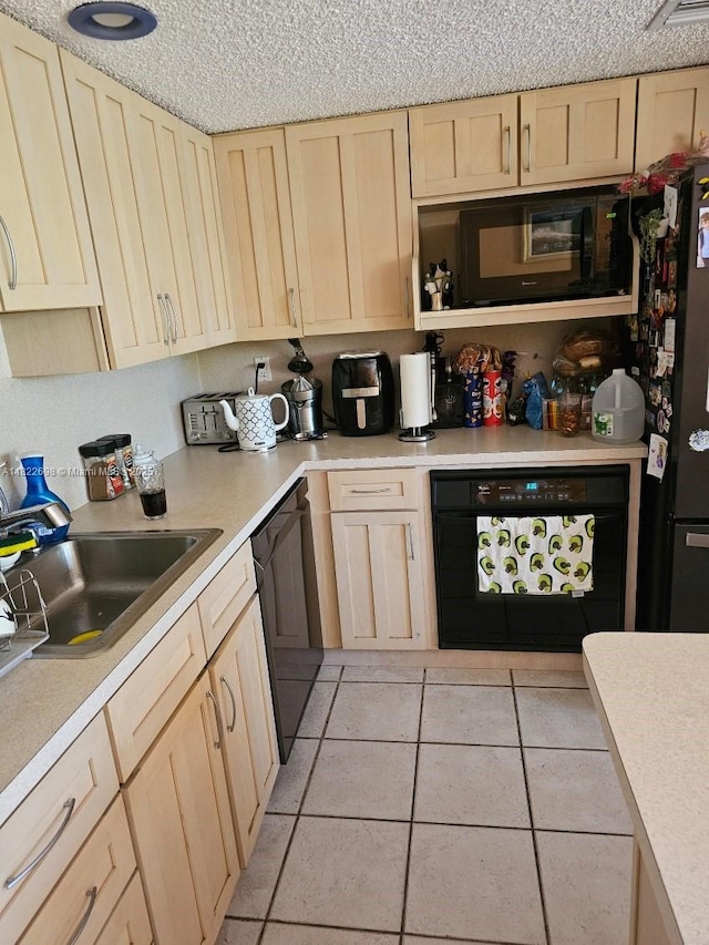2423 NE 10th St Unit 154, Hallandale Beach, FL 33009 - kitchen featuring light brown cabinets, dishwasher, black microwave, light countertops, and light tile patterned floors