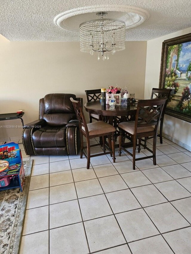 2423 NE 10th St Unit 154, Hallandale Beach, FL 33009 - dining room featuring a textured ceiling, light tile patterned flooring, and a chandelier