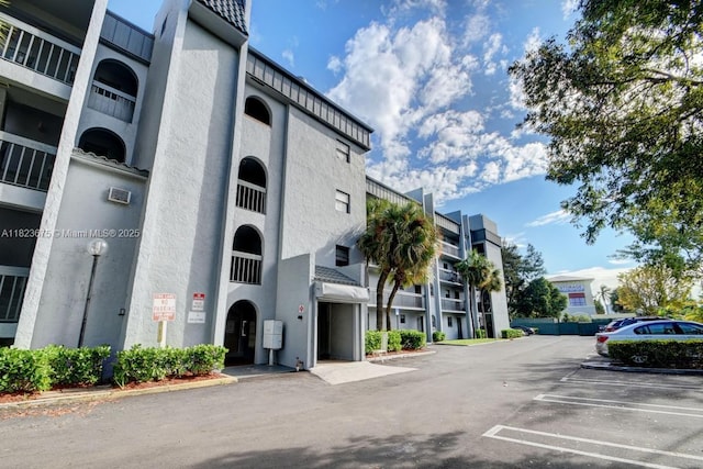 1820 N Congress Ave Unit 108, West Palm Beach, FL 33401 - view of building exterior featuring uncovered parking