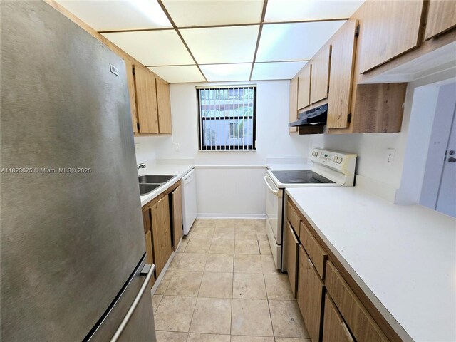 1820 N Congress Ave Unit 108, West Palm Beach, FL 33401 - kitchen featuring white appliances, under cabinet range hood, light countertops, light tile patterned floors, and a drop ceiling
