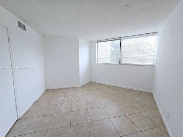 1820 N Congress Ave Unit 108, West Palm Beach, FL 33401 - empty room with a textured ceiling and light tile patterned flooring